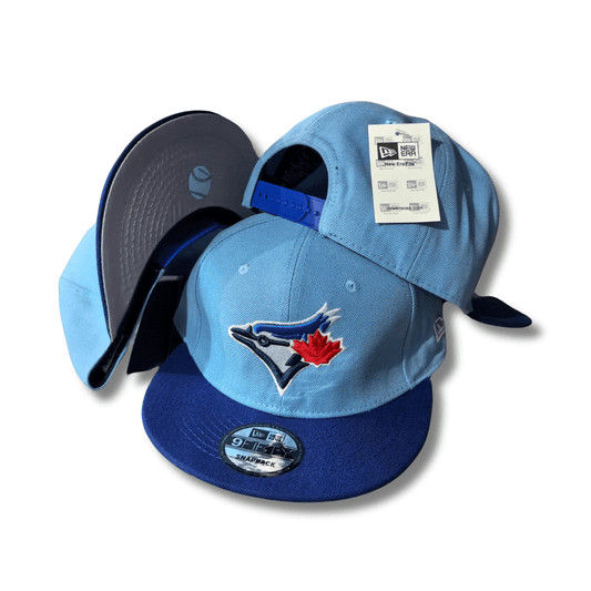 Toronto Blue Jays New Era 9FIFTY Light Blue and Royal Blue with Red Maple Leaf Logo – Snapback Cap